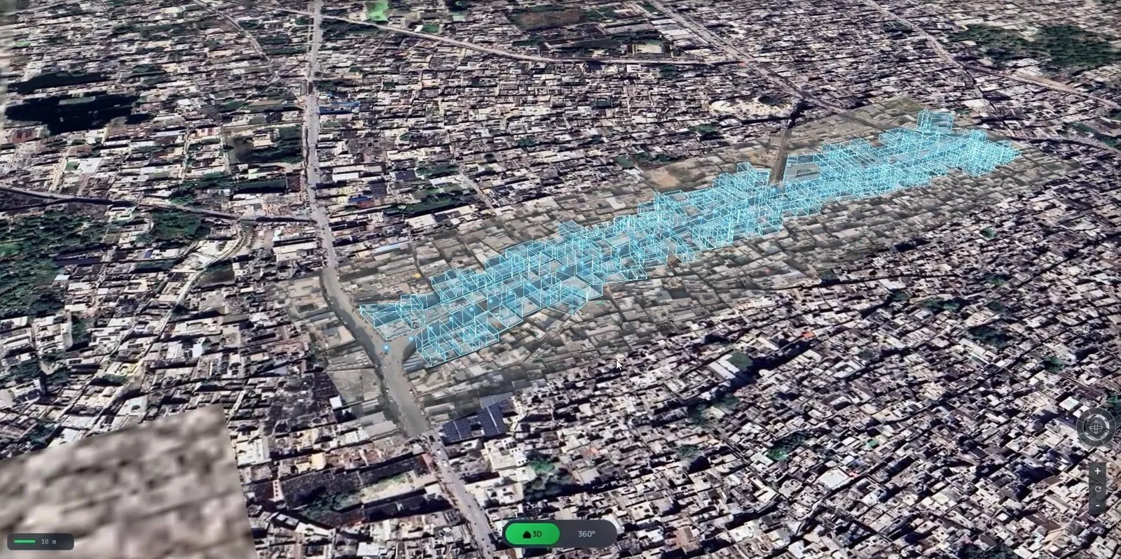 An aerial 3D view of a dense city, with the buildings along one captured street highlighted in blue.